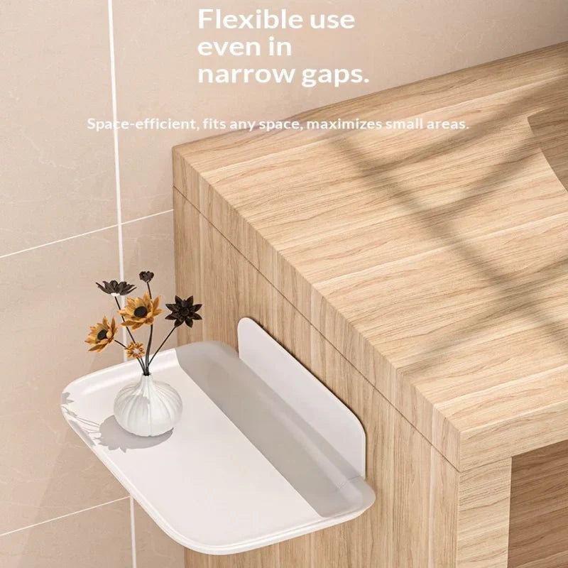 White folding shelf shown beside wooden furniture in a narrow gap