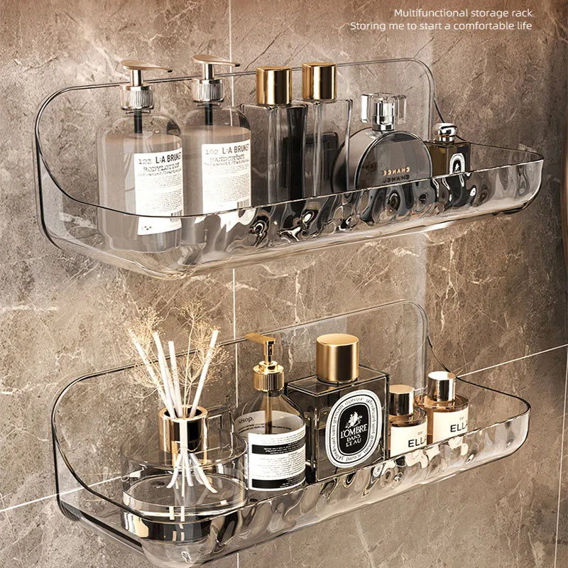Clear wall-mounted bathroom shelves holding toiletries against tiles